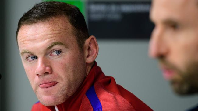 England's striker Wayne Rooney (L) gives a press conference on the eve of the World Cup 2018 football qualification match between Slovenia and England in Ljubljana, on October 10, 2016. / AFP PHOTO / Jure MAKOVEC