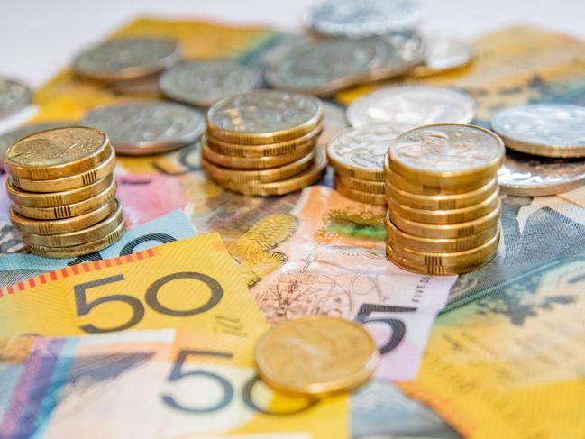 Australian notes and coins spilled out on a table, money cash generic