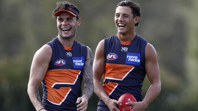 Zac Williams and Jye Caldwell have a laugh at GWS training.