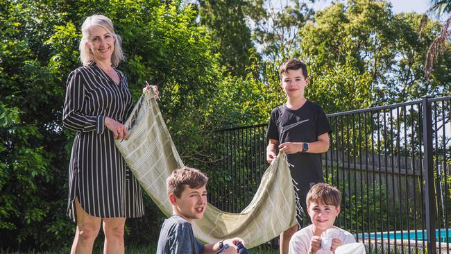 Christy Jones pays her three sons Toby, 11, Oliver, 12 and Jackson, 12, for helping with chores including sorting the washing. Picture: Flavio Brancaleone