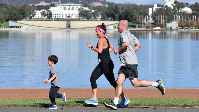 Josh Frydenberg jogs with wife Amie and son Blake in a Mother’s Day fun run on Sunday. Picture: Getty Images