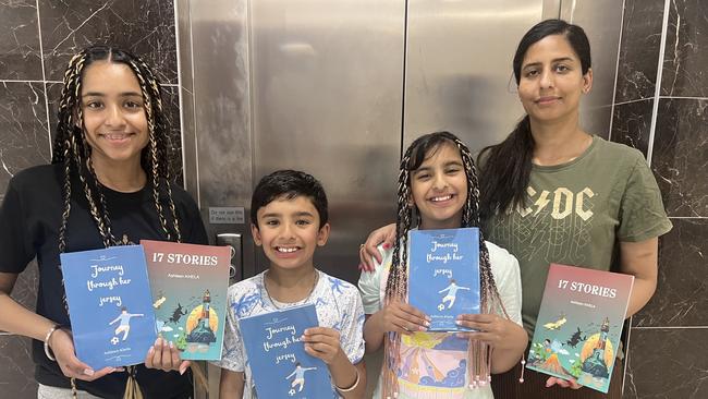 Ashleen Khela (far left) with her family holding her two books. Picture: Supplied