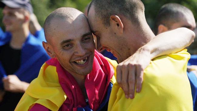 Freed Ukrainian POW wearing state flags after their exchange. Picture: Ukrainian Presidential Press Service/AFP