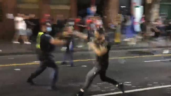 A protester throws a punch at police officer during the protest. Picture: Supplied