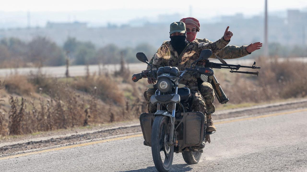 Anti-government figthers ride a motorcycle on the highway to Damascus. Picture: Omar Haj Kadour/AFP