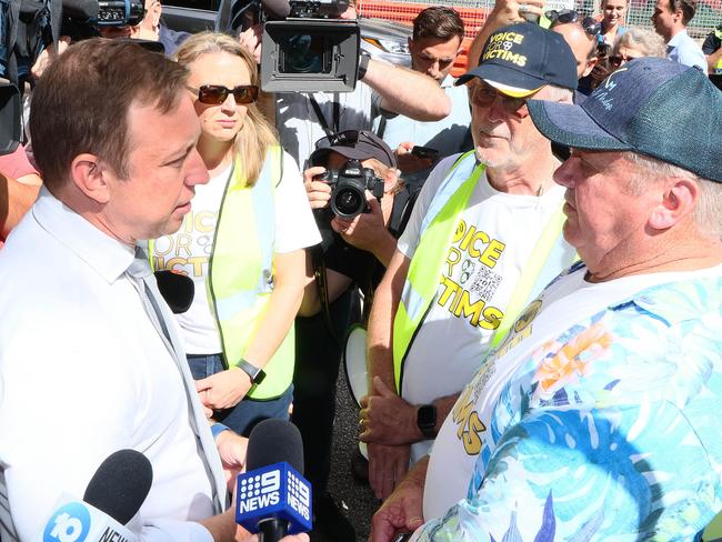 Then premier Steven Miles (left) speaks with Russell Field at a Voice For Victims rally outside Parliament.