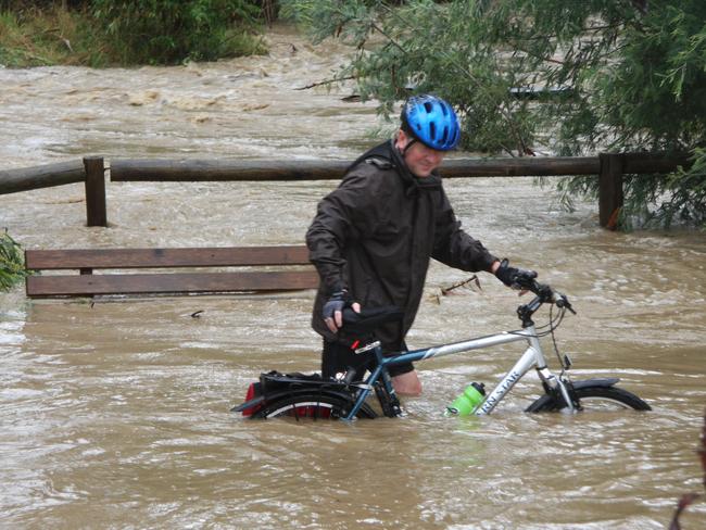 A cyclist on the bike path alongside Mullum Mullum Creek in Donvale. Water reached five metres above the normal creek height in 2011. Picture: HWT Library.