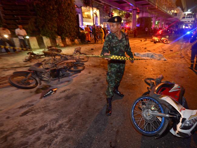 A Thai soldier ropes off the scene after a bomb exploded outside a religious shrine.