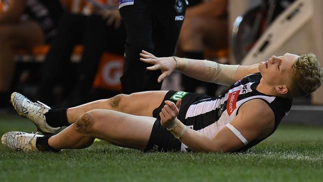 Adam Treloar is one of eight key Magpies missing with injury.