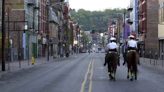 Police in riot gear patrol Cincinnati during a curfew in 1968. Picture: AP