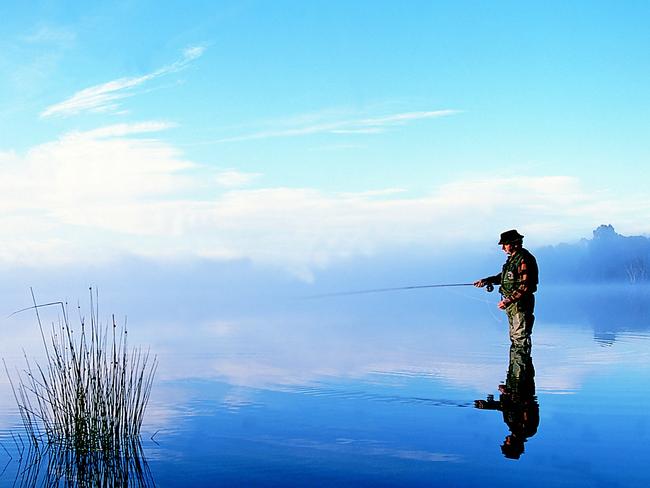 MUST CRIEDIT TOURISM TASMANIA AND PHOTOGRAPHERMan fishing at London Lakes, Tasmania. reflection reflected(Pic: George Apostolidis)