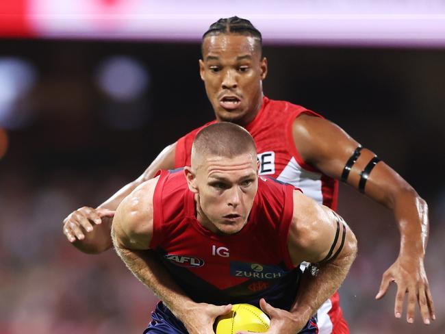 SYDNEY, AUSTRALIA - MARCH 07:  Adam Tomlinson of the Demons handles the ball during the Opening Round AFL match between Sydney Swans and Melbourne Demons at SCG, on March 07, 2024, in Sydney, Australia. (Photo by Matt King/AFL Photos/Getty Images)