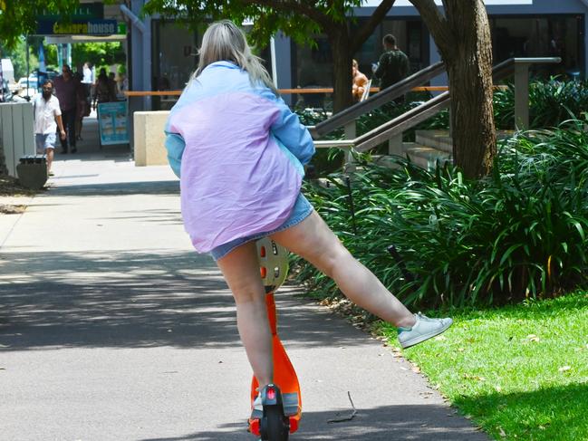 A woman riding through Darwin on an e-scooter. Picture: Julianne Osborne.