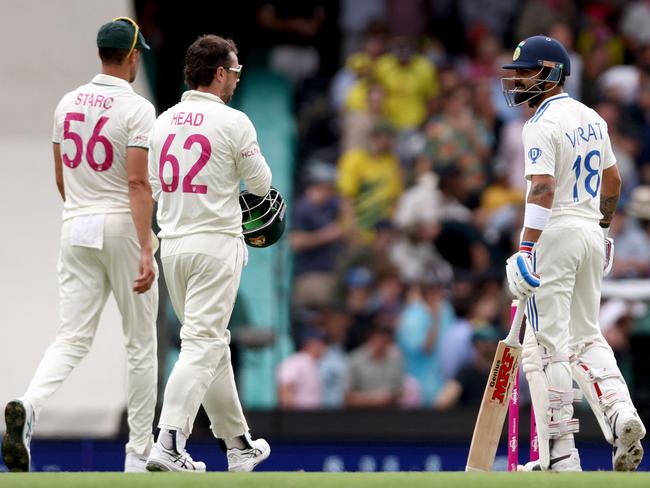 Virat Kohli, Mitchell Starc and Travis Head after the Indian’s controversial survival of a close call from the third umpire. Picture: David Gray/AFP