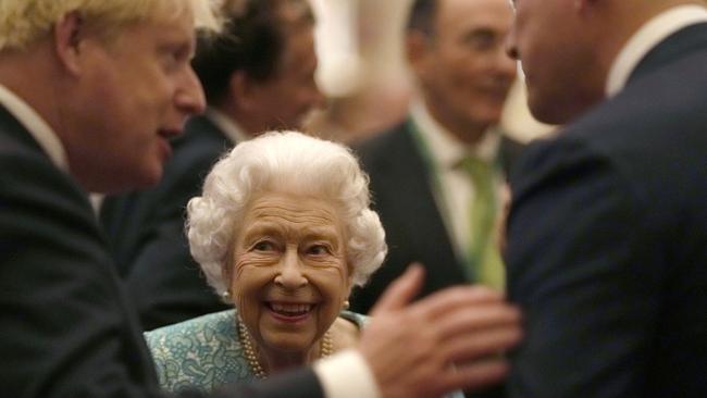 Queen Elizabeth II and former UK Prime Minister Boris Johnson greet guests during a reception at Windsor Castle in 2021. Picture: Pool/Getty Images