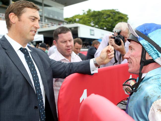 Premier Queensland trainer Tony Gollan chats with jockey Jim Byrne post-race. Picture: Jono Searle