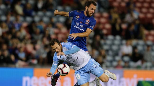 Adam Le Fondre feels the full force of a tackle from Newcastle’s Ben Kantarovski.