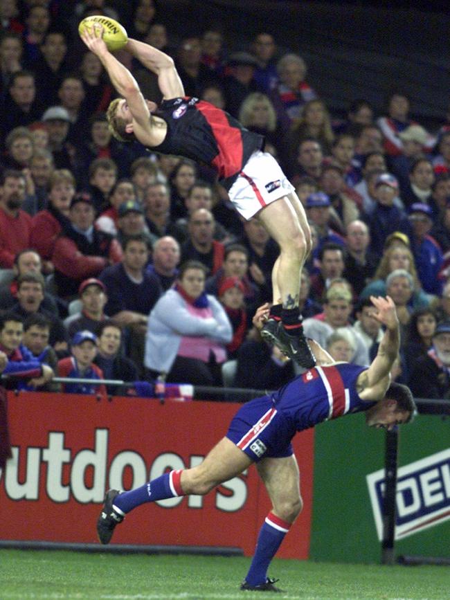 Gary Moorcroft soars over Brad Johnson.