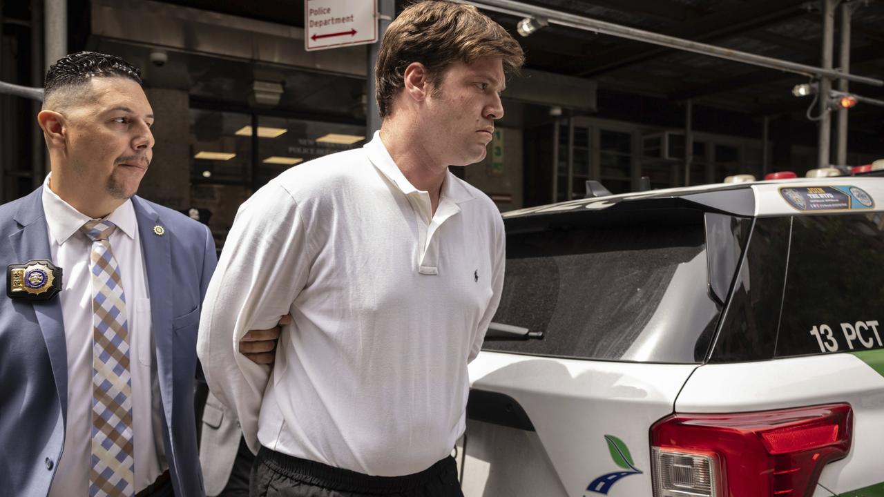 William Duplessie is escorted out of the New York Police 13th Precinct after turning himself in on charges of kidnapping and false imprisonment. Picture: AP Photo/Yuki Iwamura