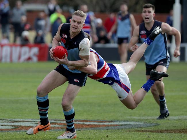 Courtney Johns of Aberfeldie is tackled by Josh Martin of Keilor.