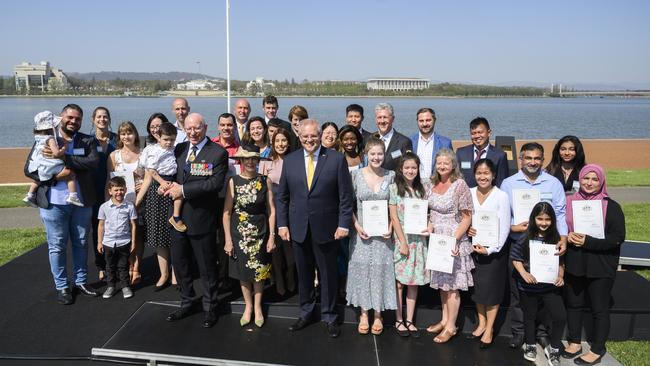 New Australians pose with Governor General David Hurley, Mrs Linda Hurley, and Prime Minister Scott Morrison at the citizenship ceremony at Lake Burley Griffin on January 26.