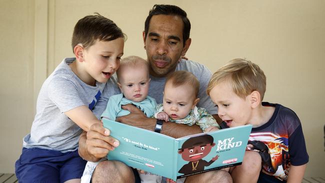 Crows star Eddie Betts reads his new book to his children Lewis 5, twins Alice and Maggie 7 months, and Billy 3. Picture: Matt Turner