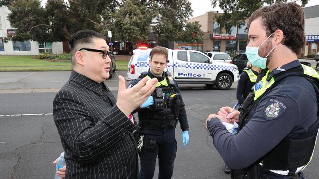 The man speaks to police outside the microchip and computer board manufacturing hub, after he crashed the campaign event. Picture: Jason Edwards