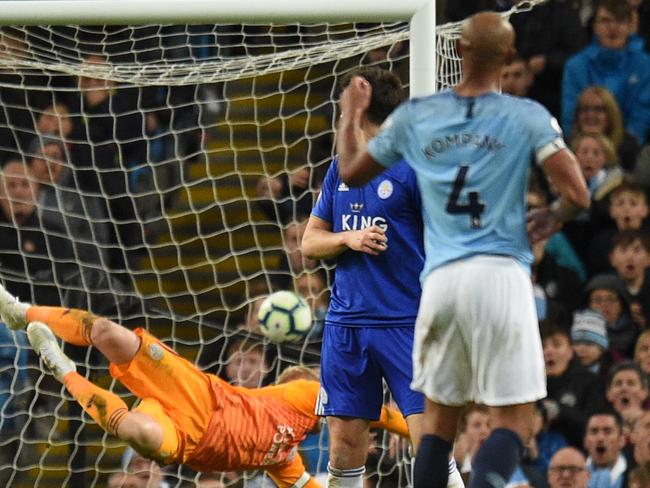 Manchester City's Belgian defender Vincent Kompany (R) watches as his shot beats Leicester City's Danish goalkeeper Kasper Schmeichel (L) to score the opening goal during the English Premier League football match between Manchester City and Leicester City at the Etihad Stadium in Manchester, north west England, on May 6, 2019. (Photo by Oli SCARFF / AFP) / RESTRICTED TO EDITORIAL USE. No use with unauthorized audio, video, data, fixture lists, club/league logos or 'live' services. Online in-match use limited to 120 images. An additional 40 images may be used in extra time. No video emulation. Social media in-match use limited to 120 images. An additional 40 images may be used in extra time. No use in betting publications, games or single club/league/player publications. /