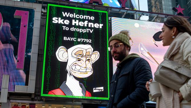 People walk by a Bored Ape Yacht Club NFT billboard in Times Square in New York City last week. Picture: Noam Galai/Getty Images