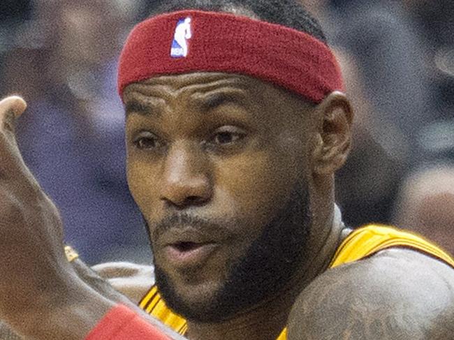 Cleveland Cavaliers forward LeBron James (23) drives to the basket past Toronto Raptors forward Terrence Ross, right, during the first half of an NBA basketball game, Friday, Dec. 5, 2014 in Toronto. (AP Photo/Canadian Press, Nathan Denette)