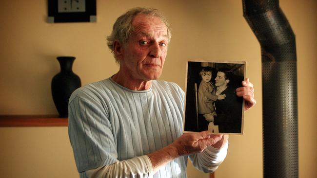 Raymond “Muscles” Kane holding a picture of his brother Les and niece Suzanne.