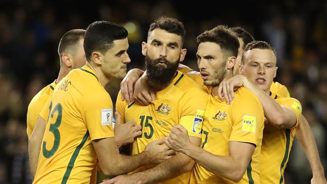 Mile Jedinak of Australia celebrates with team mates after scoring a penalty.