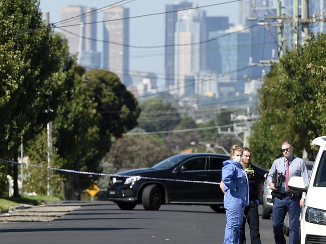 Police descended on Horton Street the day after the alleged murder. Picture: Andrew Henshaw