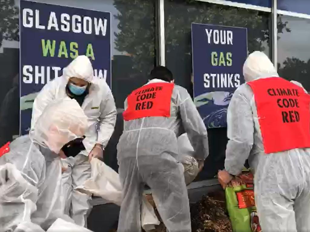 Extinction Rebellion protesters were dressed in hazmat suits when they left the huge pile of dung outside the Hilton premises. Picture: Facebook