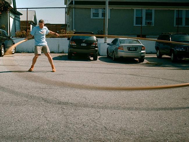 He gets a really massive hula hoop and spins it three times. 