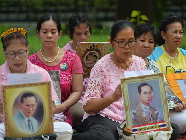 Women hold portraits of Thai King Bhumibol Adulyadej as they pray for his health at Siriraj Hospital in Bangkok, where he is being treated. Picture: AFP/Munir Uz Zaman