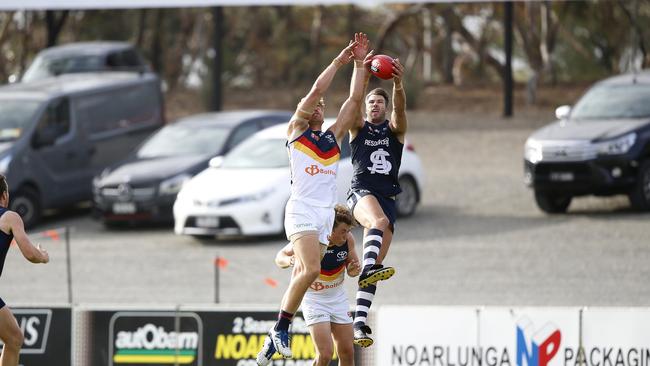 South’s Keegan Brooksby marking over Adelaide’s Harry Dear. Picture: Deb Curtis.