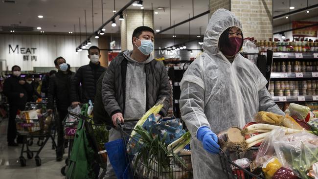 Residents wear protective masks as they line up in the supermarket in Wuhan, Hubei province, China. (Photo by Stringer/Getty Images)