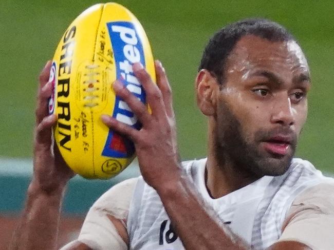 Travis Varcoe of the Magpies runs with the ball during an AFL reserves scratch match between the Collingwood Magpies and the Richmond Tigers at the Melbourne Cricket Ground in Melbourne, Wednesday, June 10, 2020. (AAP Image/Scott Barbour) NO ARCHIVING