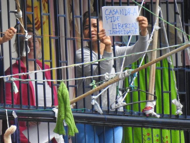 Sainsbury with a fellow inmate holding a sign asking for her freedom at El Buen Pastor women’s prison. Picture: Nathan Edwards