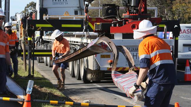 SA Power Networks and road workers removed the downed Stobie pole, knocked over when a man driving a black ute slammed into it on Tapleys Hill Rd and died. Picture: Emma Brasier.