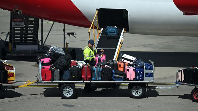 Baggage handlers loading a Qantas aircraft at Brisbane Airport after the airline outsourced the work to third-party companies. Picture: Dan Peled