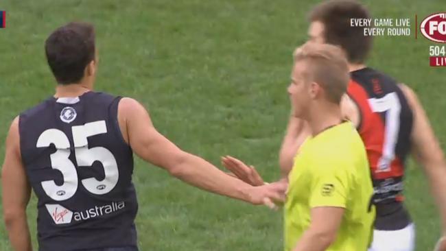 Carlton’s Ed Curnow appears to lightly push the umpire in the game against Essendon