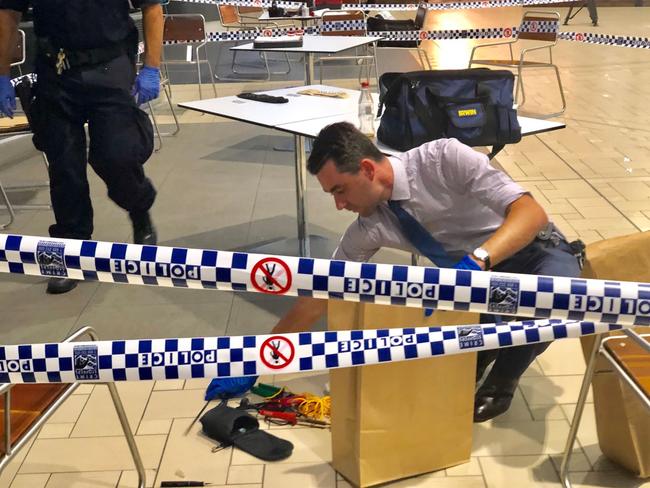 Police inspect items allegedly seized from the man. Picture: Sarah Marshall/AAP 