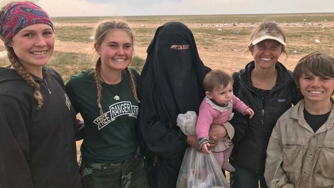 Australian woman Zehra Duman (centre) holding her daughter with aid workers in Syria.