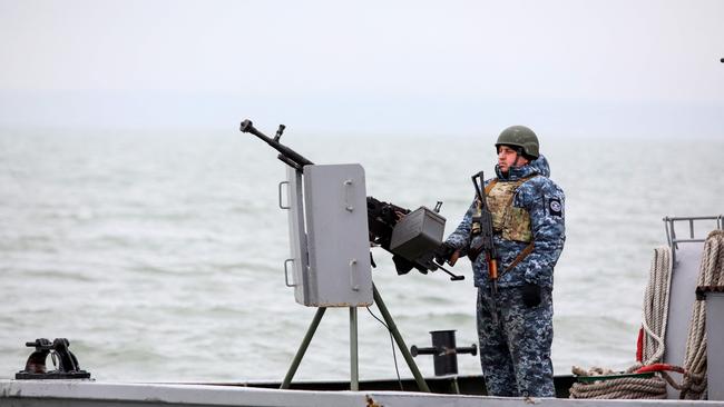 A serviceman patrolling the waters around Ukraine's Black Sea port of Mariupol. Picture; AFP.