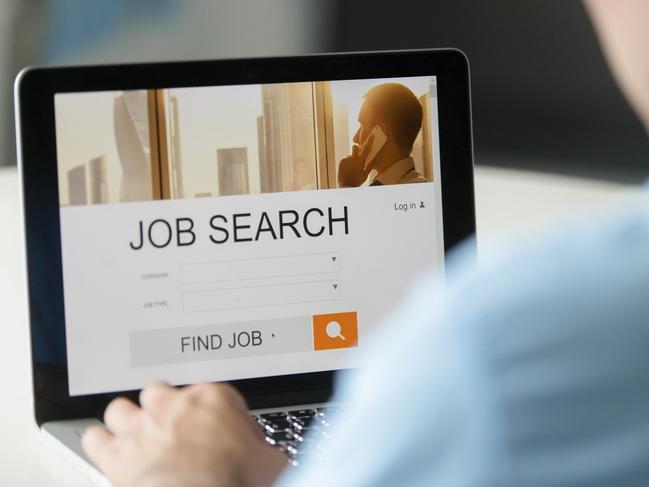 Monitor view over a male shoulder, job search title on the screen, close up. Education, business concept photo