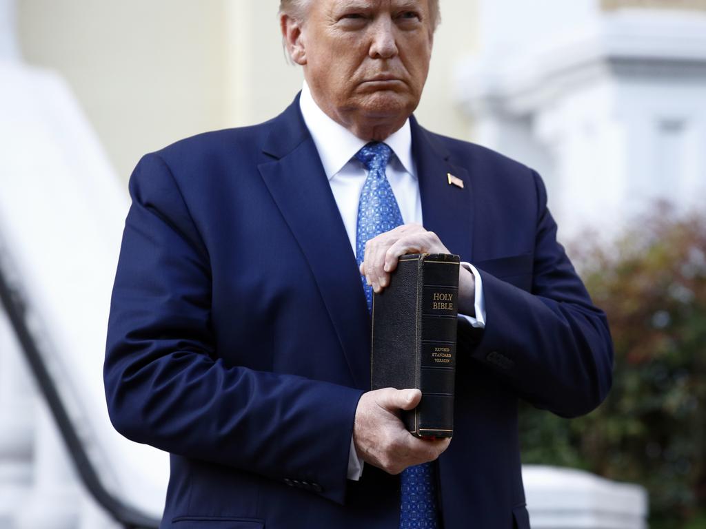 President Donald Trump holds a Bible as he visits outside St. John's Church across Lafayette Park from the White House in Washington. Picture: Patrick Semansky