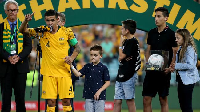 Tim Cahill with his children on stage after his final game for the Socceroos. Picture: Toby Zerna