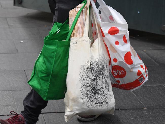 A shopper is seen carrying bags at a Coles Sydney CBD store, Sydney, Monday, July 2, 2018. Woolworths says it will hand out free reusable bags for the next 10 days as its customers get used to its ban on single-use plastic bags. Woolies stores in NSW, Queensland, Victoria and Western Australia stopped providing free single-use plastic bags on June 20. (AAP Image/Peter RAE) NO ARCHIVING